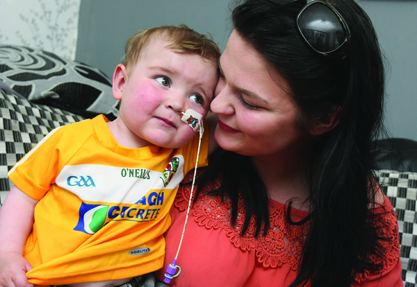 TOGETHER: Seph Ní Mhealláin holds her son Dáithí in their Ballymurphy home 