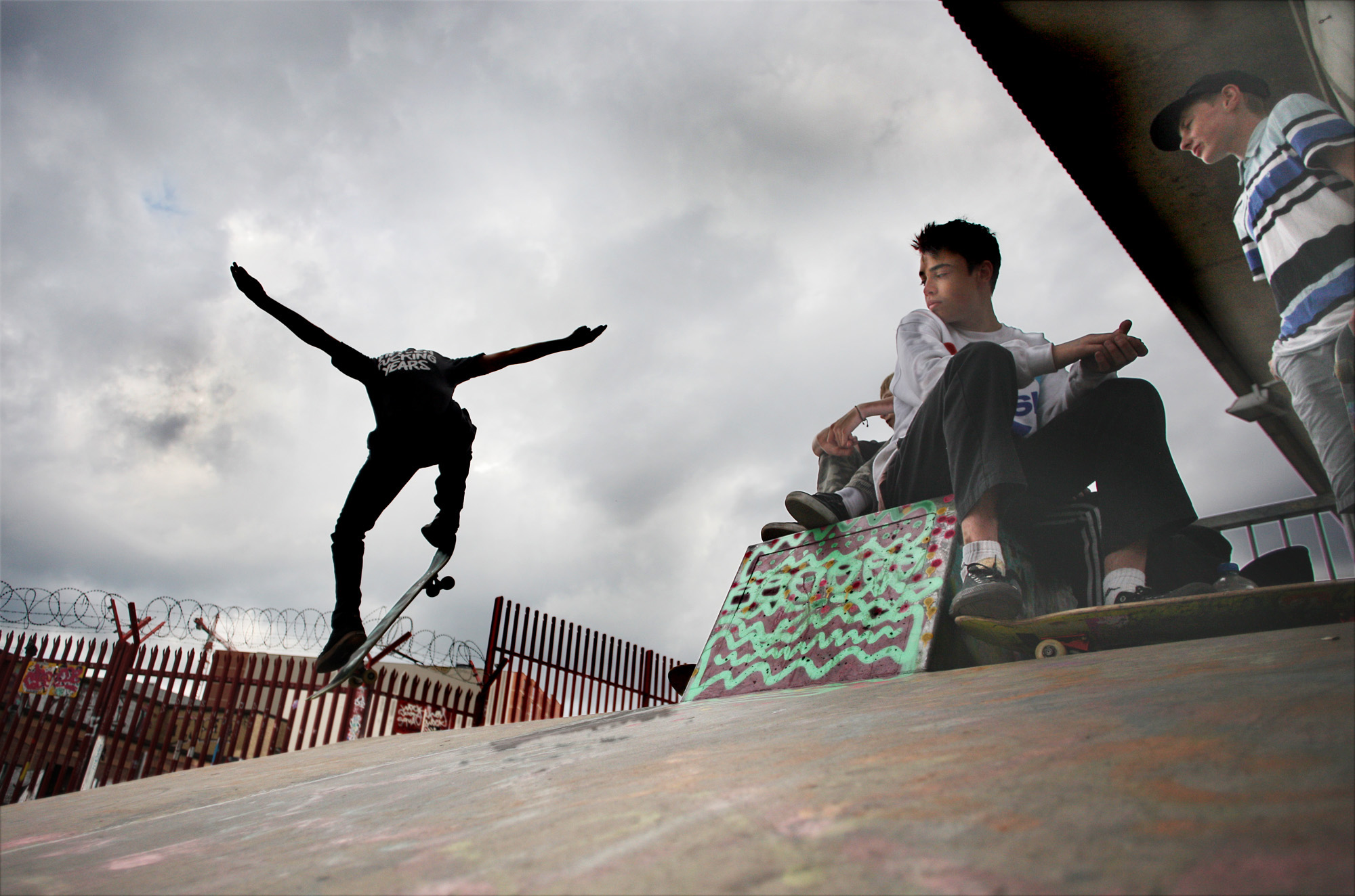 Flying under the flyover – skater boys hanging out in Little Patrick Street skate park underneath the M3