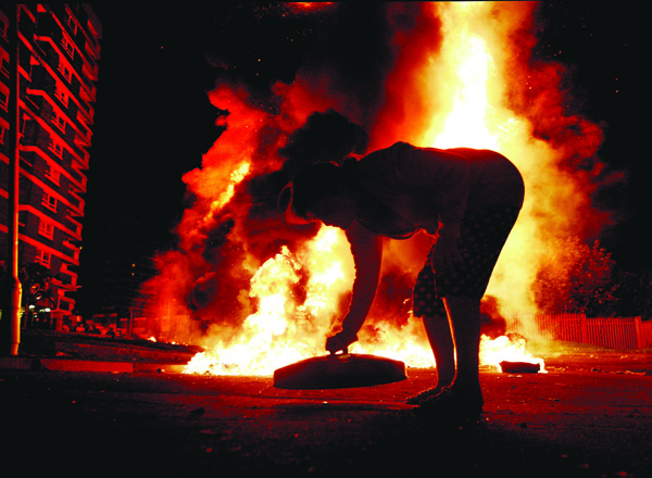 Hot in the City\nBaning the binlid at an anti internment bonfire