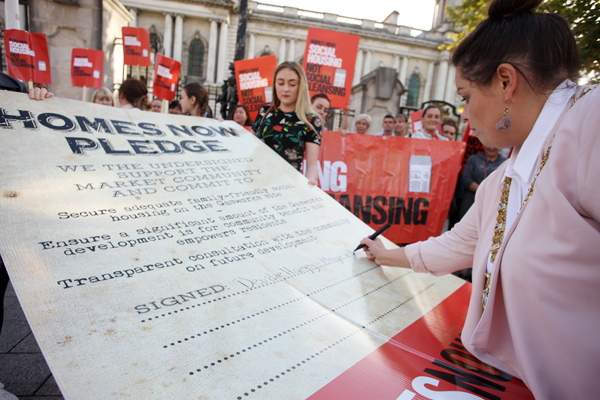 Belfast Lord Mayor Deirdre Hargey signs the Homes Now pledge outside City Hall on Monday night