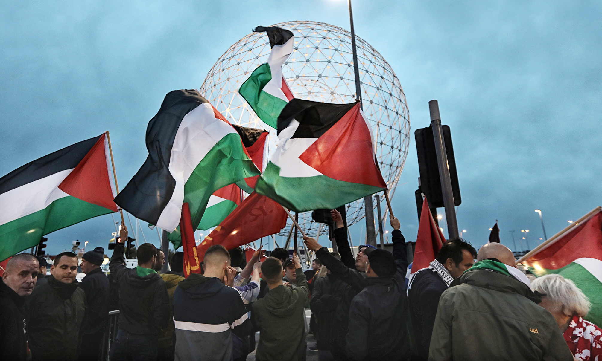 Pro-Palestine protestors at the Rise sculpture on Broadway Roundabout last night as Northern Ireland took on Israel in a friendly half a mile away at Windsor Park