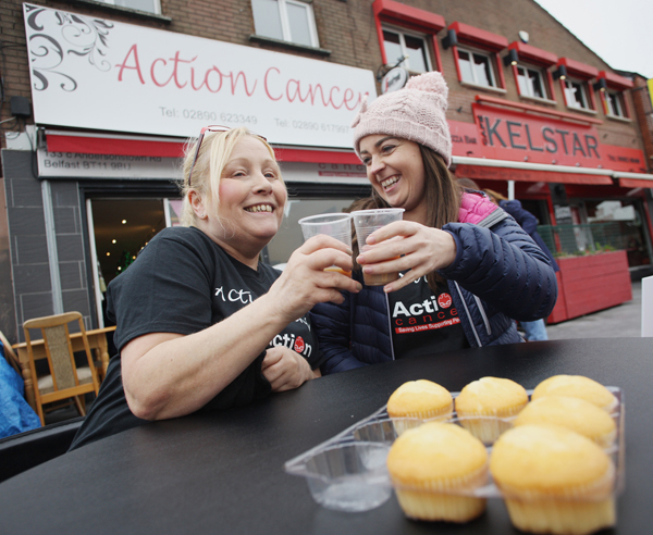 Action Cancer Andersonstown staff Teresa Ryan and Lynette Coleman taking a well-deserved break as staff from Bank of Ireland and the Andersonstown News took over the running of the shop for a day on Friday as part of the Action Cancer Store Challenge
