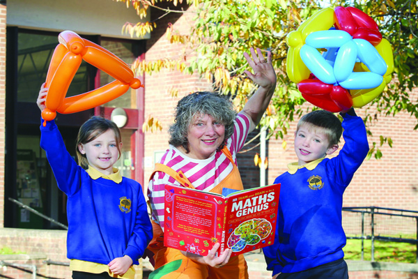 COUNT ON IT: Belvoir Park Primary School Year 3 pupils Maisie and Jude with maths entertainer Bubblz (Caroline Ainslie) outside Ormeau Road Library