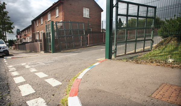 Red white and blue painted kerbs outside Holy Cross Girls PS on Ardoyne Road