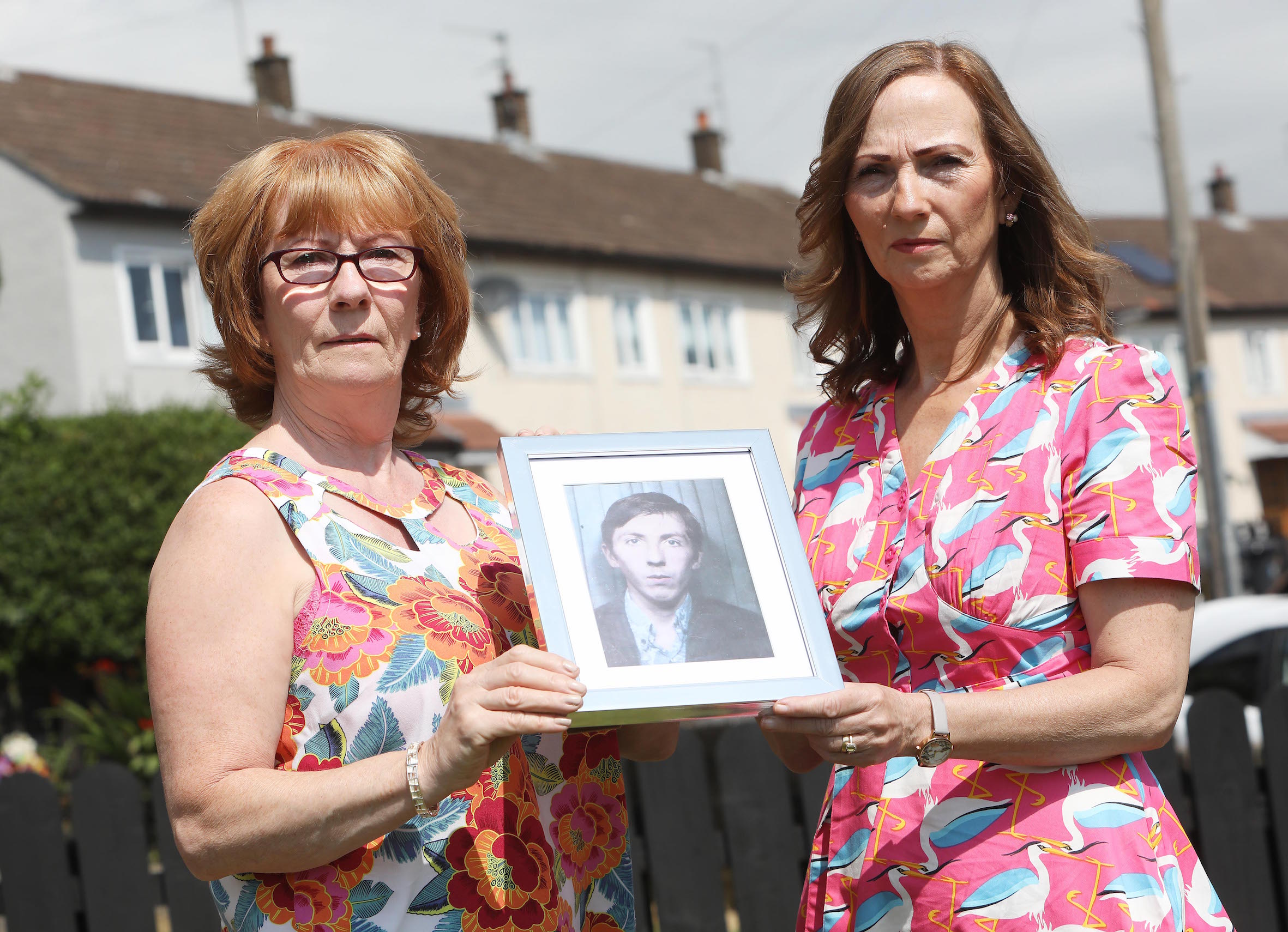 Rita Bonner and Carmel Quinn with photographs of their brother John Laverty who was shot dead by British Soldiers in the Ballymurphy Massacre 1971 0607JC18