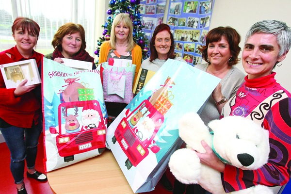 APPEAL: Deirdre Walsh, Ihintz Oliden and Maura Maguire of the Whiterock Children\'s Centre, with Joanne Enright, Trisha Monahan and Mary O\'Rawe of Sure Start, urging the community to help local families in need this Christmas by donating clothes, toys and non-perishable foods