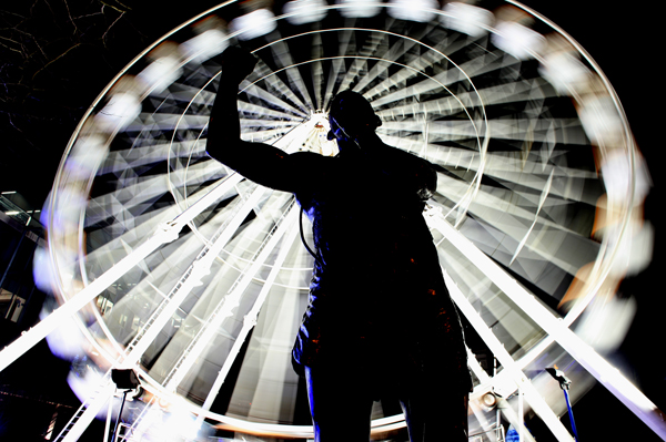 Back in the limelight: A statue of boxer Rinty Monaghan at Cathedral Gardens where it is illuminated by the big wheel, which is aimed at attracting  shoppers into the city centre in the run-up to Christmas