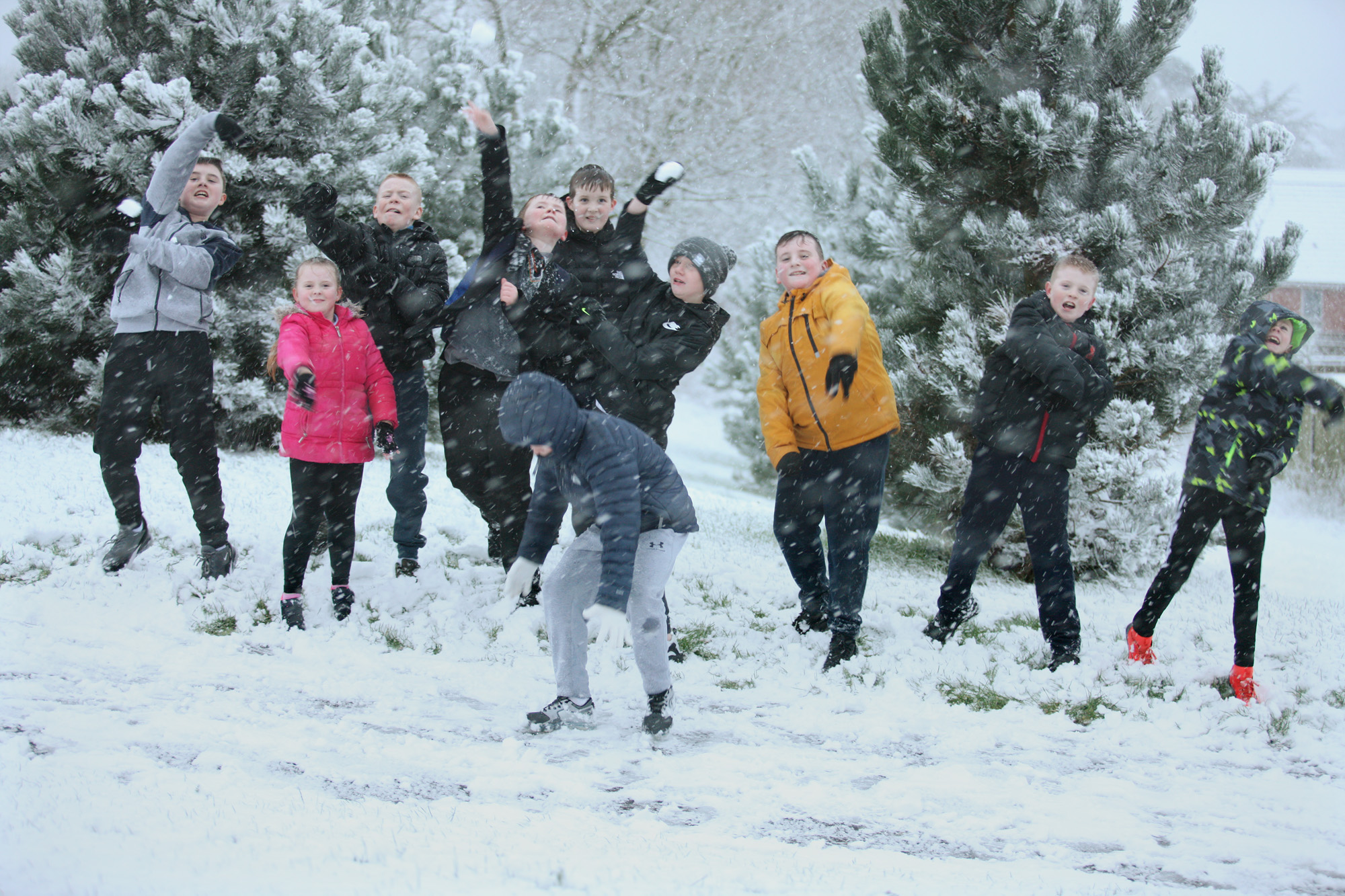 Children in Ligoniel enjoyed the snow fall as they returned home from school yesterday