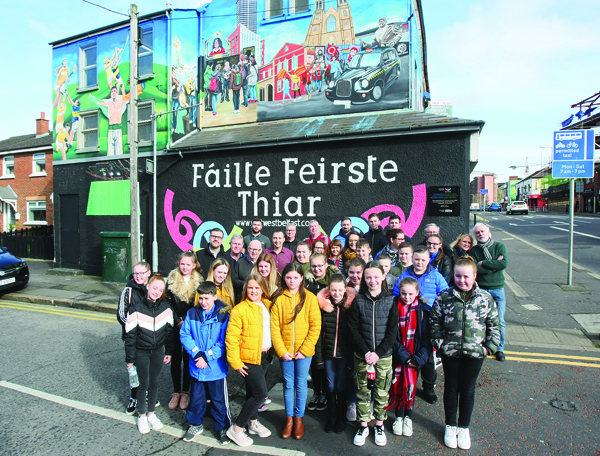 Fáilte Feirste Thiar staff along with young people at the unveiling of their new mural