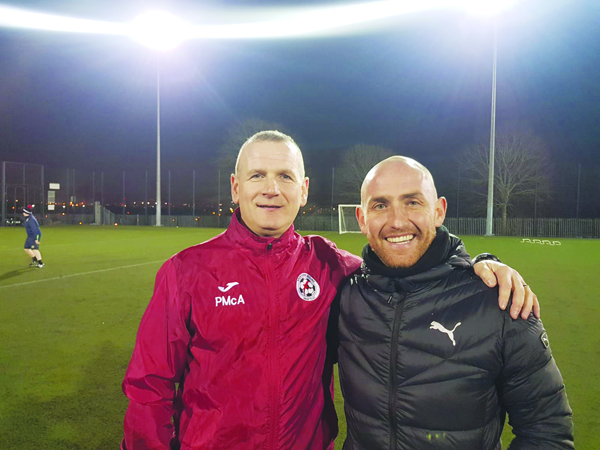 Cliftonville legend Barry Johnston, pictured above with Sport and Leisure Swifts manager Packie McAllister, has returned to his coaching role with the West Belfast outfit