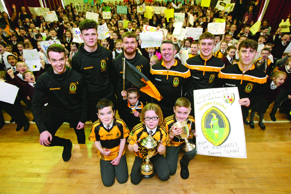 Players from Naomh Éanna GAC pop into St Bernards Primary School in Glengormley to get a great big send-off as the local team prepares for the big game against Kilcummin on Saturday – the All-Ireland Intermediate Club Championship final 