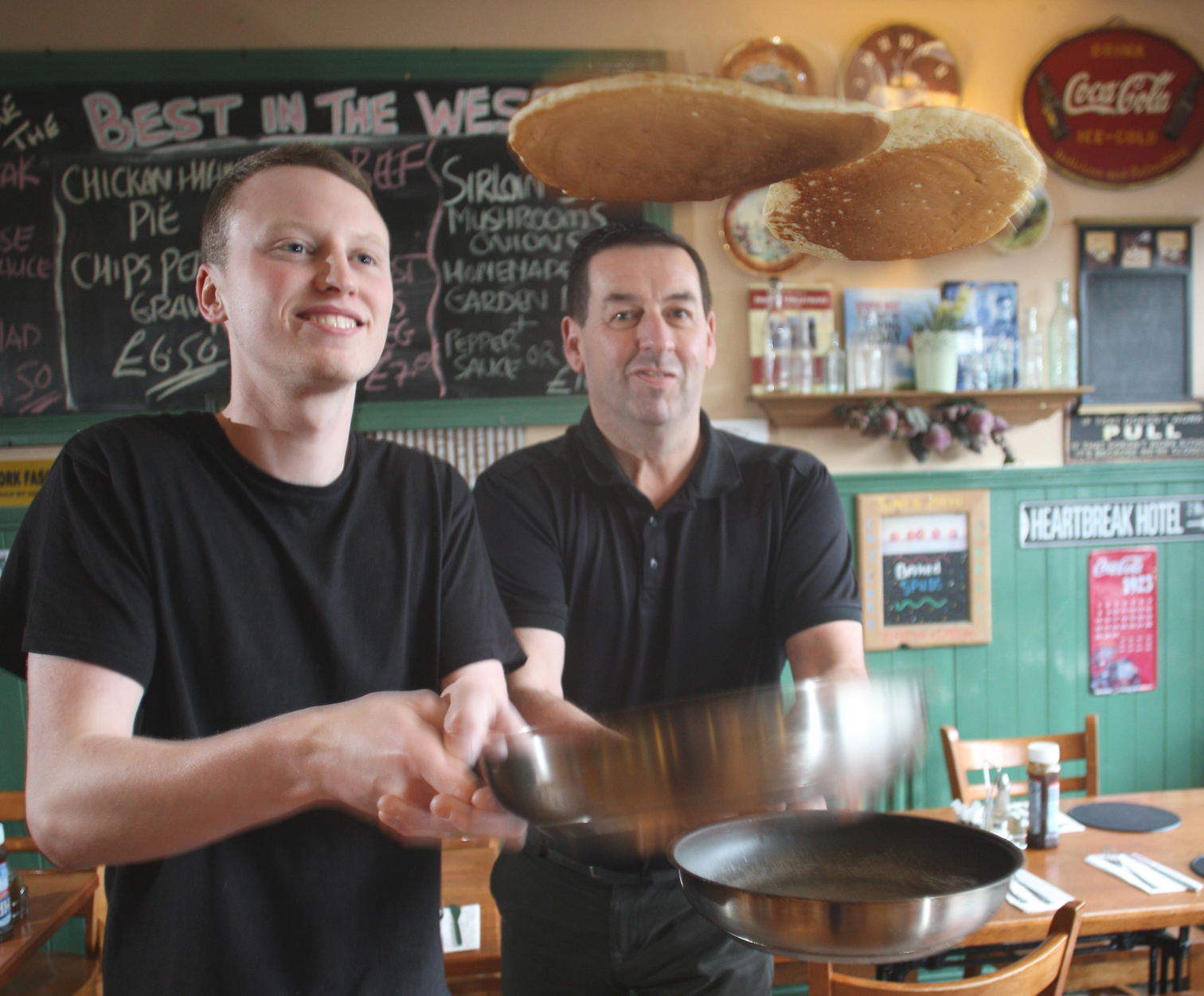 Expertly tossing pancakes in the Coffee House ahead of Lent getting under way are Jim McIlwaine and Sean Devine 