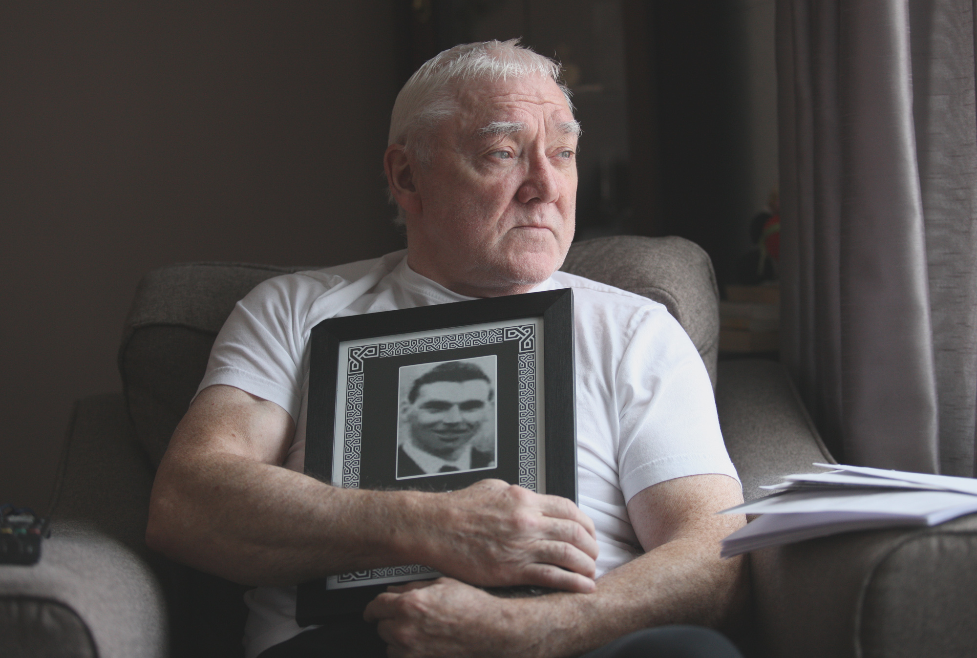 COURT CASE: Anthony Thompson with a treasured family portrait of his brother David