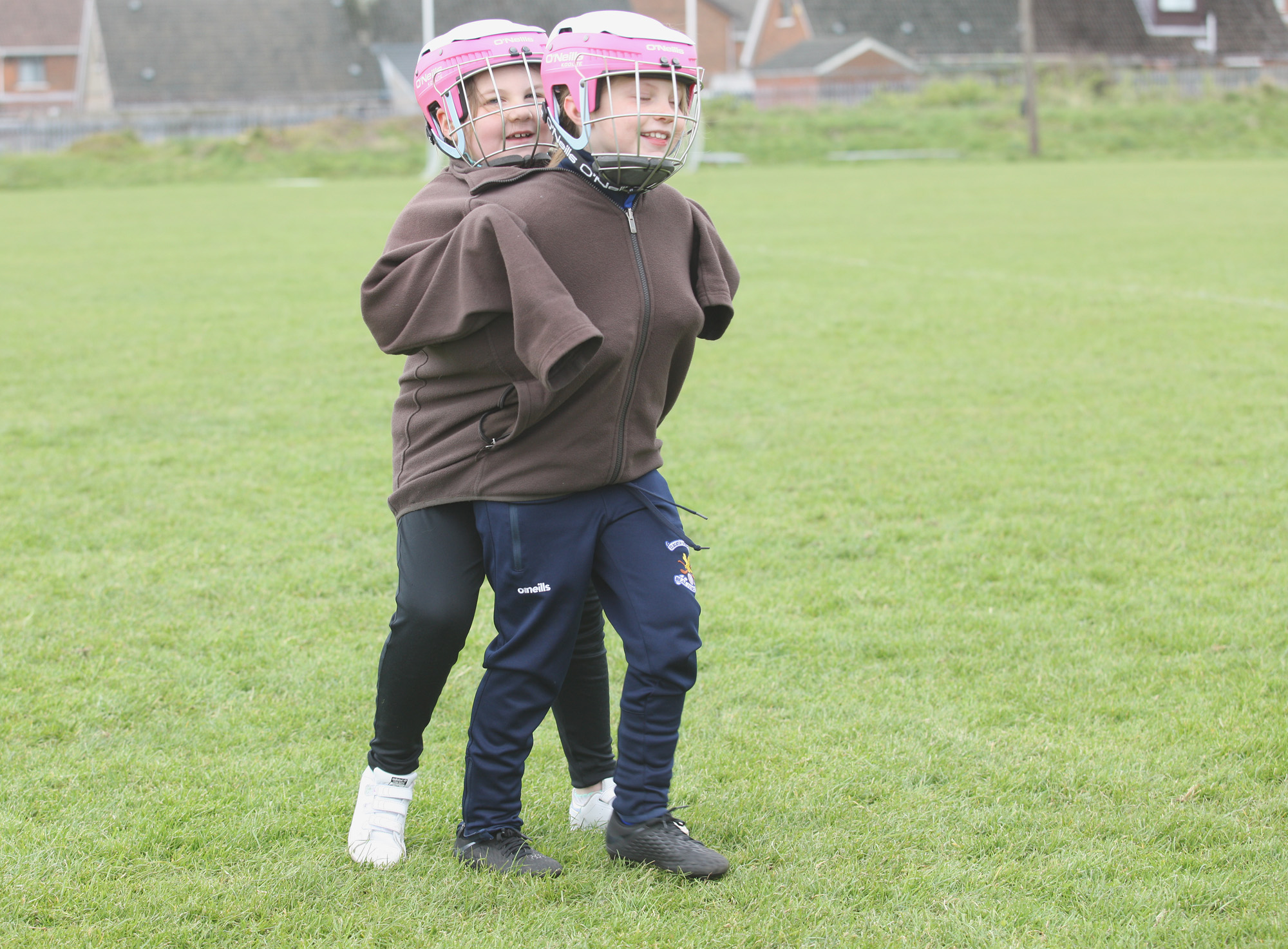 CHILD\'S PLAY: Two youngsters keep warm during an under-8s camogie tournament at Sarsfields  CLG 