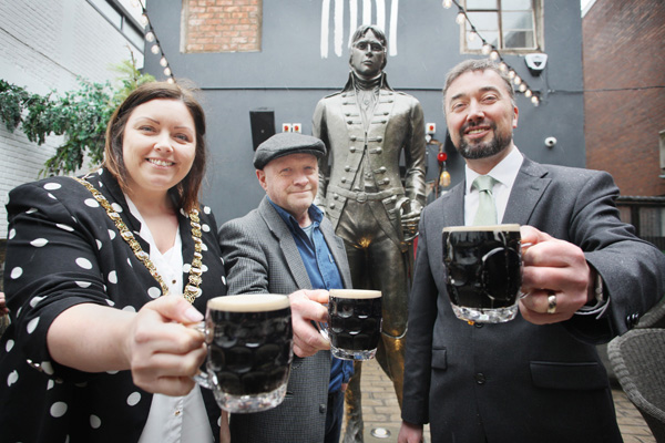 Toasting the new Henry Joy McCracken statue at the Jail House in Joys Entry are sculptor Steve Finney, Lord Mayor Deirdre Hargey and Christopher McCracken, a descendant of the legendary United Irishman