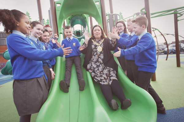 Lord Mayor Deirdre Hargey enjoying the new St Theresa\'s PS playpark with pupils at yesterday\'s offiicial opening. The playpark has been dedicated to Serenity Joubert, who tragically passed away last year 