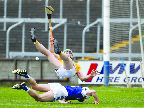 Antrim captain Conor McCann, pictured following a collision with Laois defender Joe Phelan in their Joe McDonagh Cup round two clash, expects another tough battle when the Saffrons take on Offaly in O’Connor Park, Tullamore on Saturday afternoon