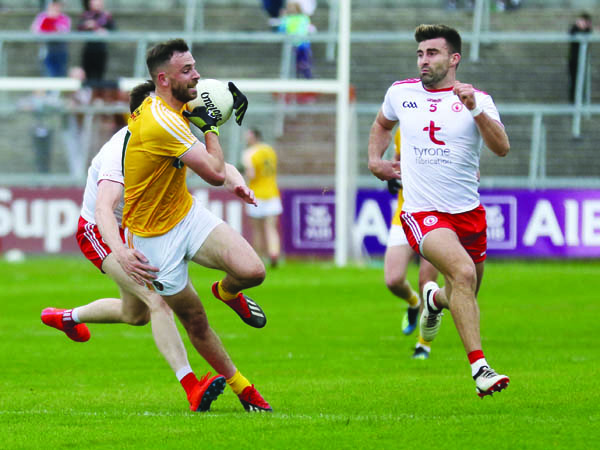 Antrim’s Matthew Fitzpatrick, pictured in action against Tyrone pair Colm Cavanagh and Tiernan McCann, feels the time is right for a tiered Championship format in football