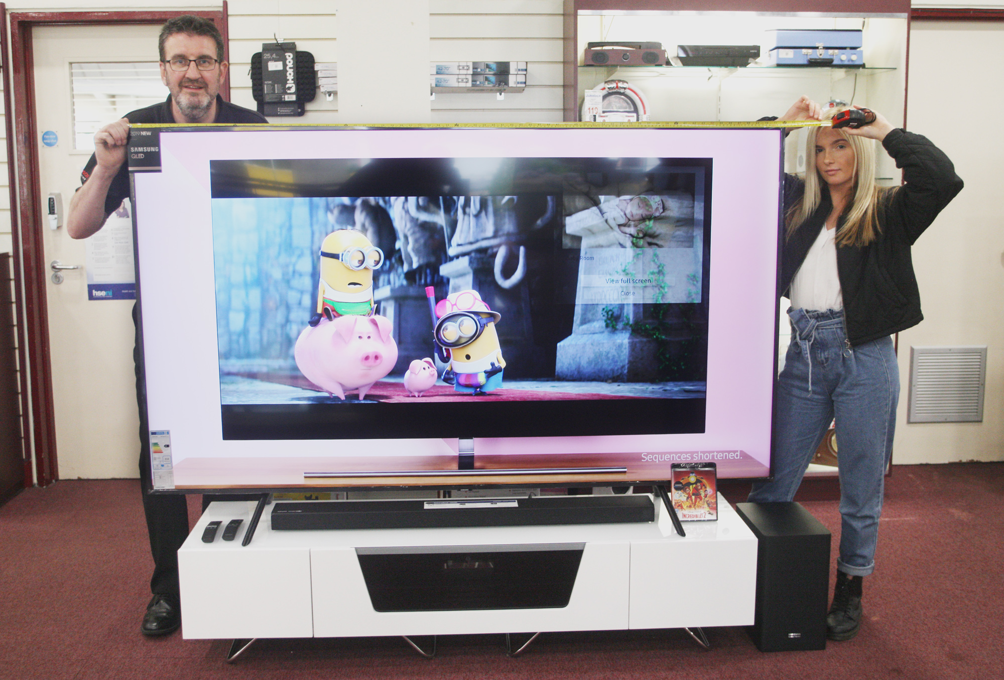 Noal Grimley and Susan Donnan measure the giant 82 inch TV