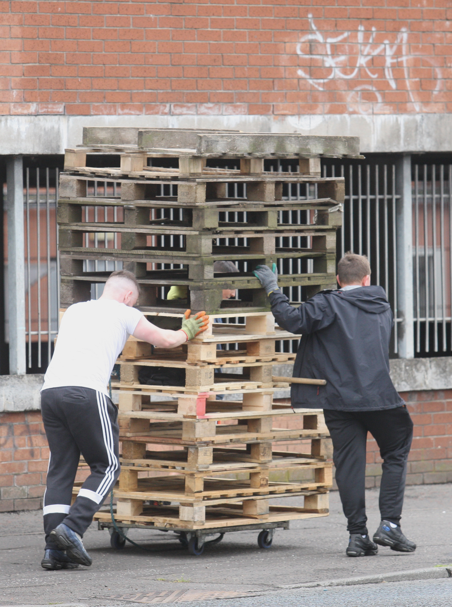 NUISANCE: Youths bring pallets given to them by local firms to the New Lodge using a borrowed trolley