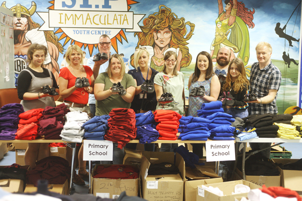 Food bank volunteers handing out school uniforms at Immaculata Youth Centre 
