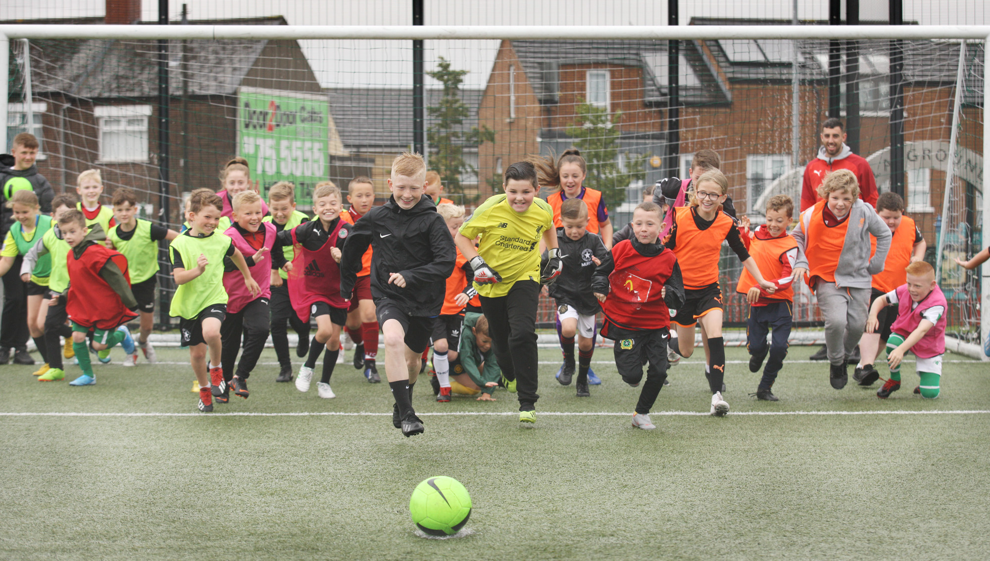 Children at the Ardoyne and Bone Community Festival Mini World Cup held at the Marrowbone Millennium Park with Joe \'the Goal\' Gormley of Cliftonville FC