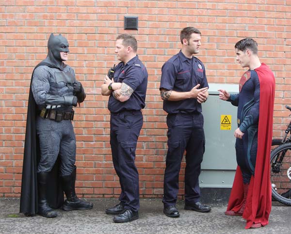 Real heroes meet fantasy heroes as firefighters chat with Batman and Superman at a community event in the New Lodge
