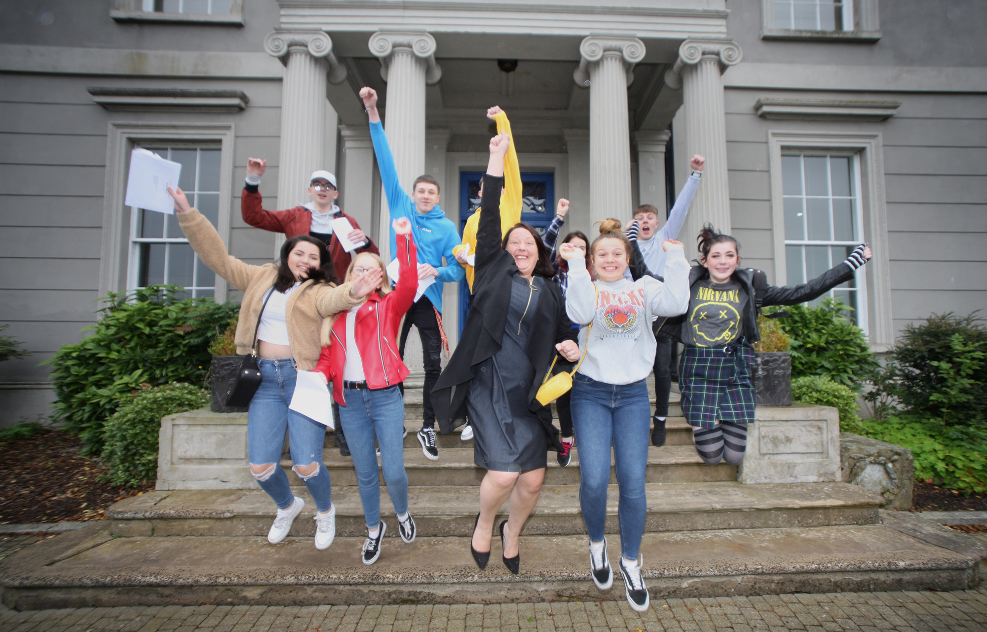 Hazelwood Integrated College pupils celebrate their GCSE results with Principal Maire Thompson