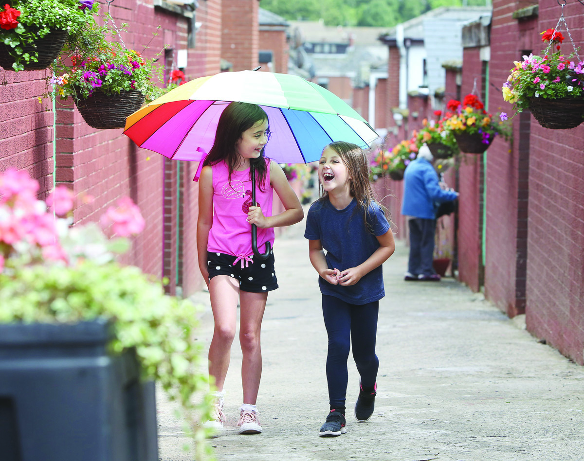 OASIS: Darcey Devlin and Ava O\'Sullivan are delighted with the new-look garden alley at Berwick Road which has been brought about by the Ardoyne Association
