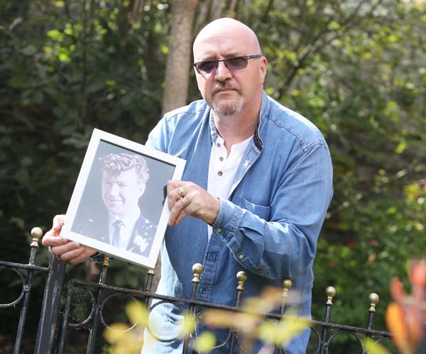 POGROM: Sam McLarnon with a picture of his father Samuel (27) murdered 50 years ago in August 1969\n