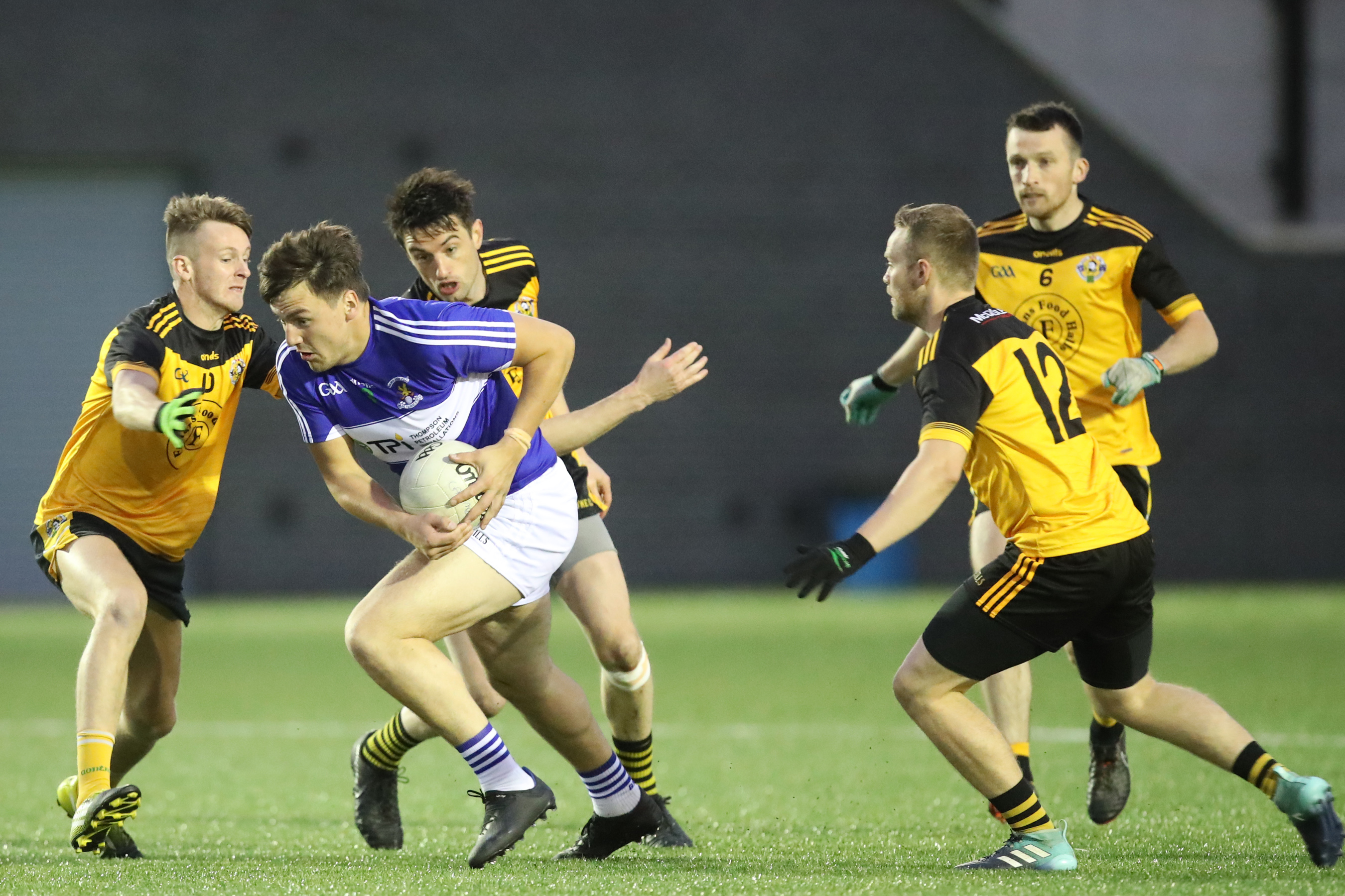 St John’s midfielder Domhnall Nugent comes under pressure from Portglenone’s Niall McKeever and Ronan Kelly during last night’s Antrim SFC replay at Coláiste Feirste 