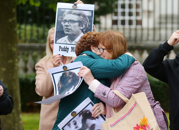 Relatives comfort each other on the final day of scheduled evidence at the Ballymurphy Inquest