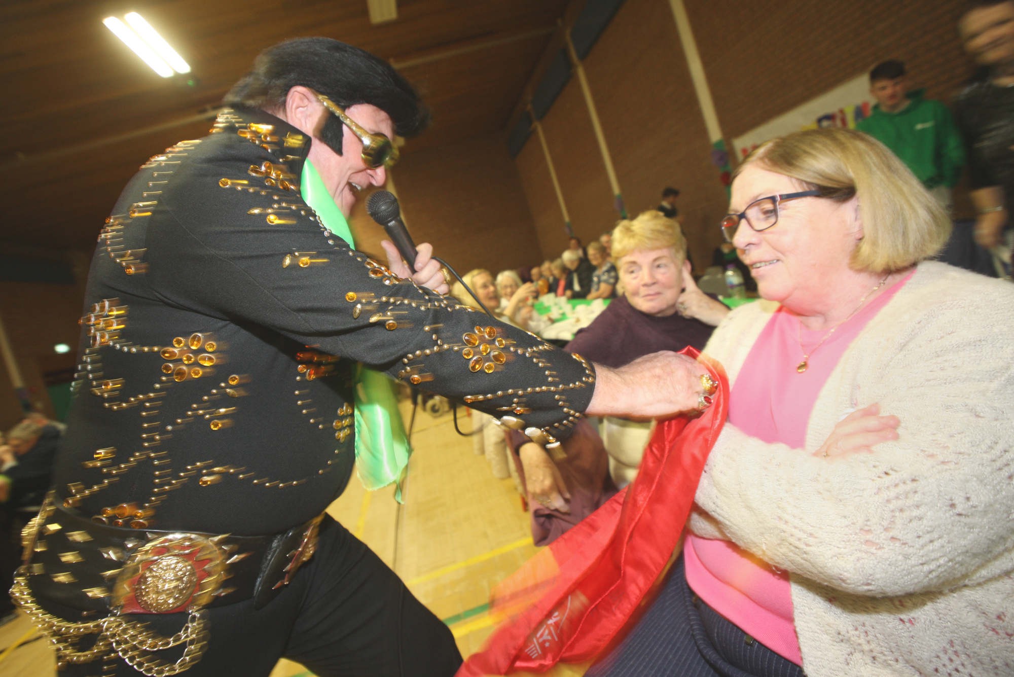 Birthday girl Margaret Coyle gets extra attention from Elvis at the Colin Youth Development Centre intergenerational Mental Health Awareness Day