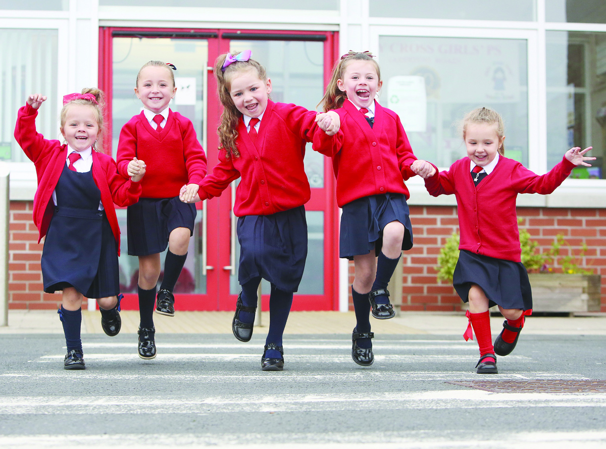 Holy Cross Girls\' Primary School P1s Mia McKee, Aoife McAlea, Priya Close, Aoibhe Murphy and Cara Quinn jump for joy in the playground