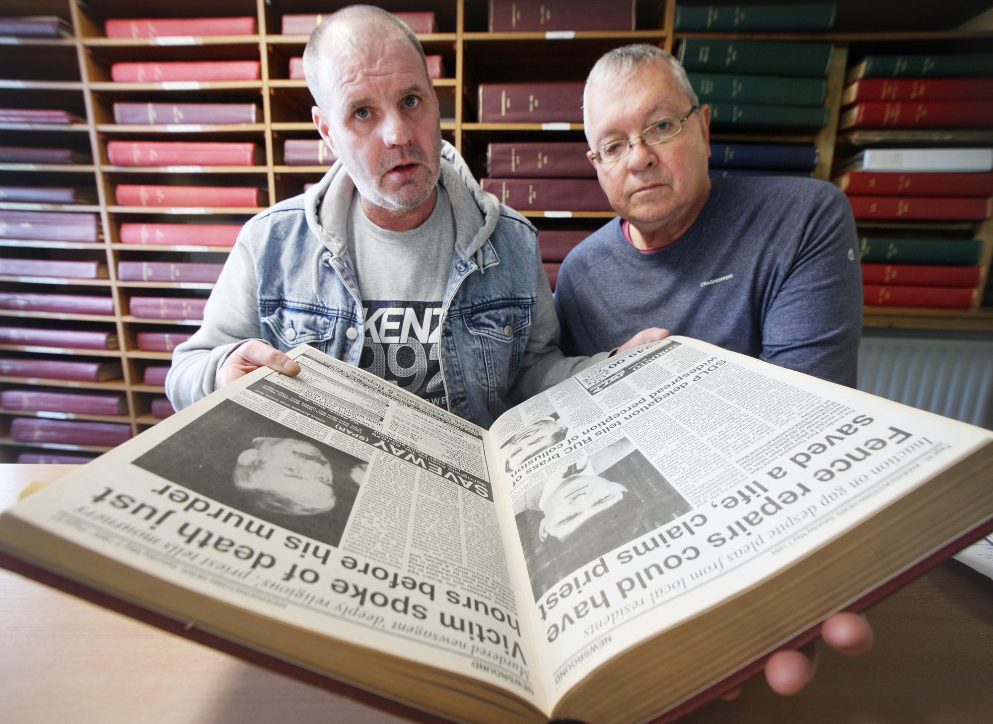 EVIDENCE: Paul Thompson’s brother Eugene and Mike Ritchie of Relatives for Justice study Andersonstown News reports of the murder