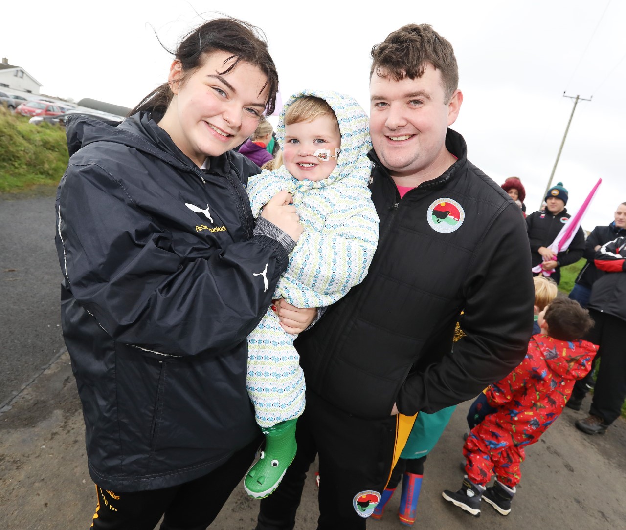 West Belfast \'superhero\' Dáithí Mac Gabhann and his parents Seph and Máirtín wrap up warm with others to walk Divis Mountain as part of Féile na Carriage