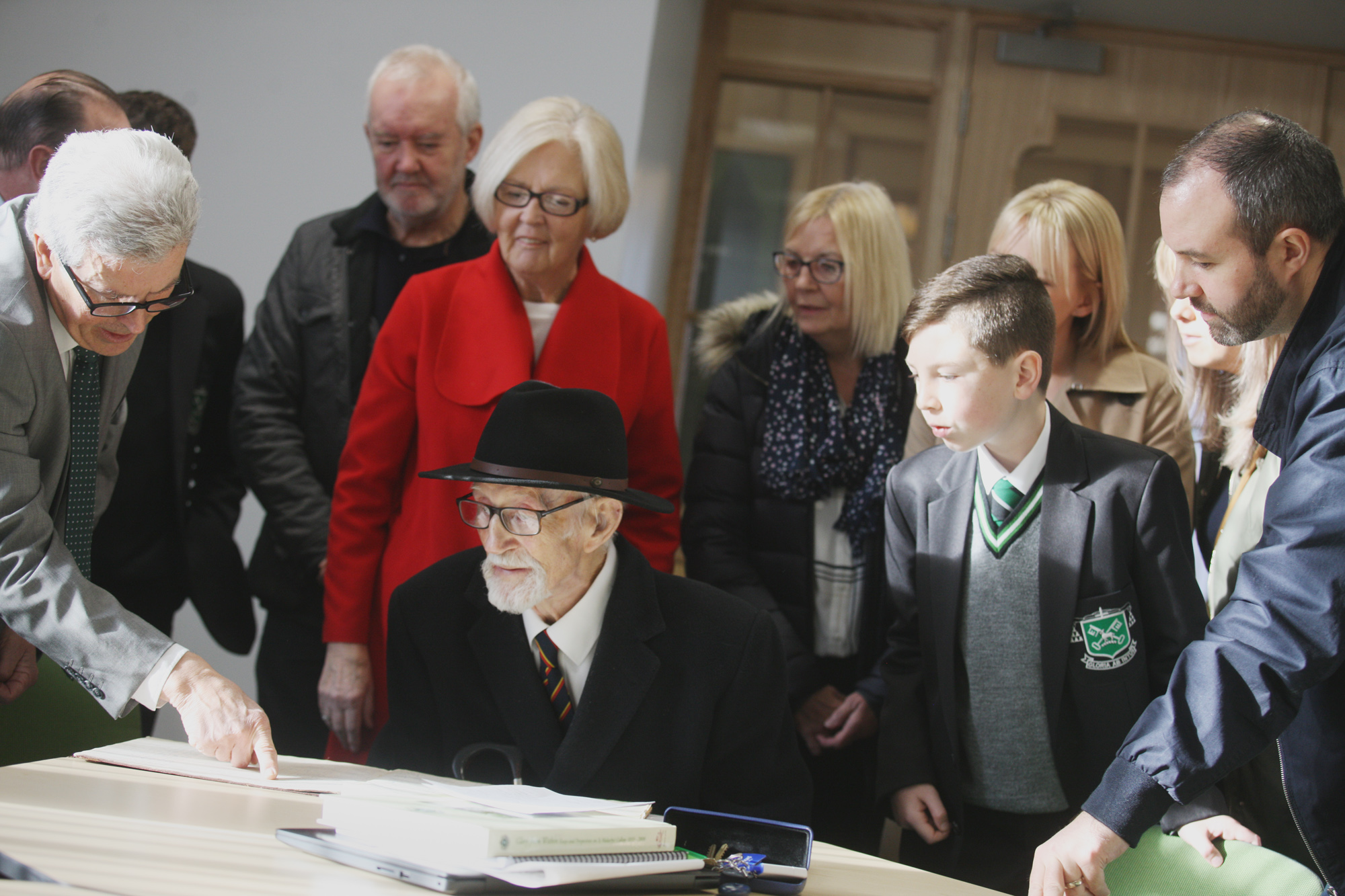 CENTENARIAN: A week ahead of his 100th birthday, Malachian William Pimpley is shown an old school report by St Malachy’s College Archivist Gerry McNamee. Also pictured is Year 8 pupil Deaglan Pimley who is carrying on the Pimley family name at the school. 