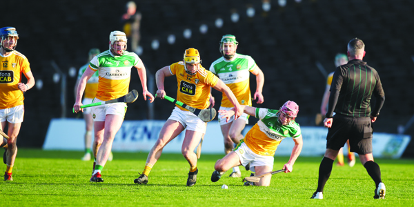 Conor Johnston brushes past Peter Geraghty to gain possession on Sunday.\nPic by John McIlwaine