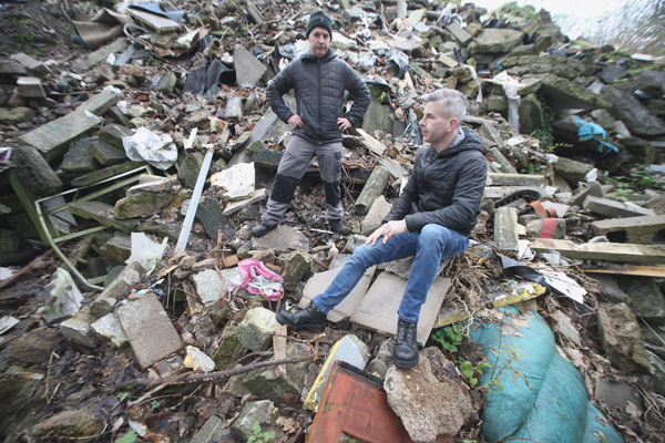 DEVASTATED: Cllr Steven Corr with Milltown resident Junior McKee, who discovered the jaw-dropping extent of dumping on the site