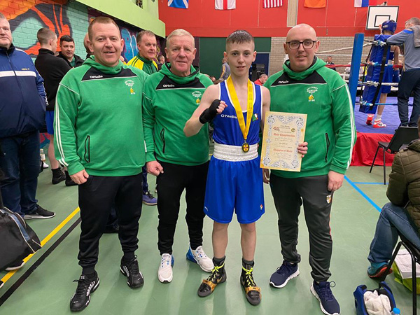Holy Trinity\'s Kyle Smith celebrating his Ulster title win in Newry at the weekend with club coaches Michael Hawkins, Ciaran Scullion (left) and Robert Fisher (right)