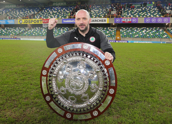 Cliftonville boss Paddy McLaughlin celebrates winning the County Antrim Shield at Windsor Park on Tuesday night
