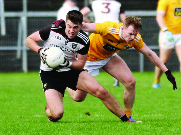 Antrim’s Peter Healy attempts to halt Sligo captain Paddy O’Connor during Sunday’s clash in Markievicz Park. The Naomh Éanna clubman feels the Saffrons must win their remaining five league games to give themselves a fighting chance of gaining promotion from Division Four