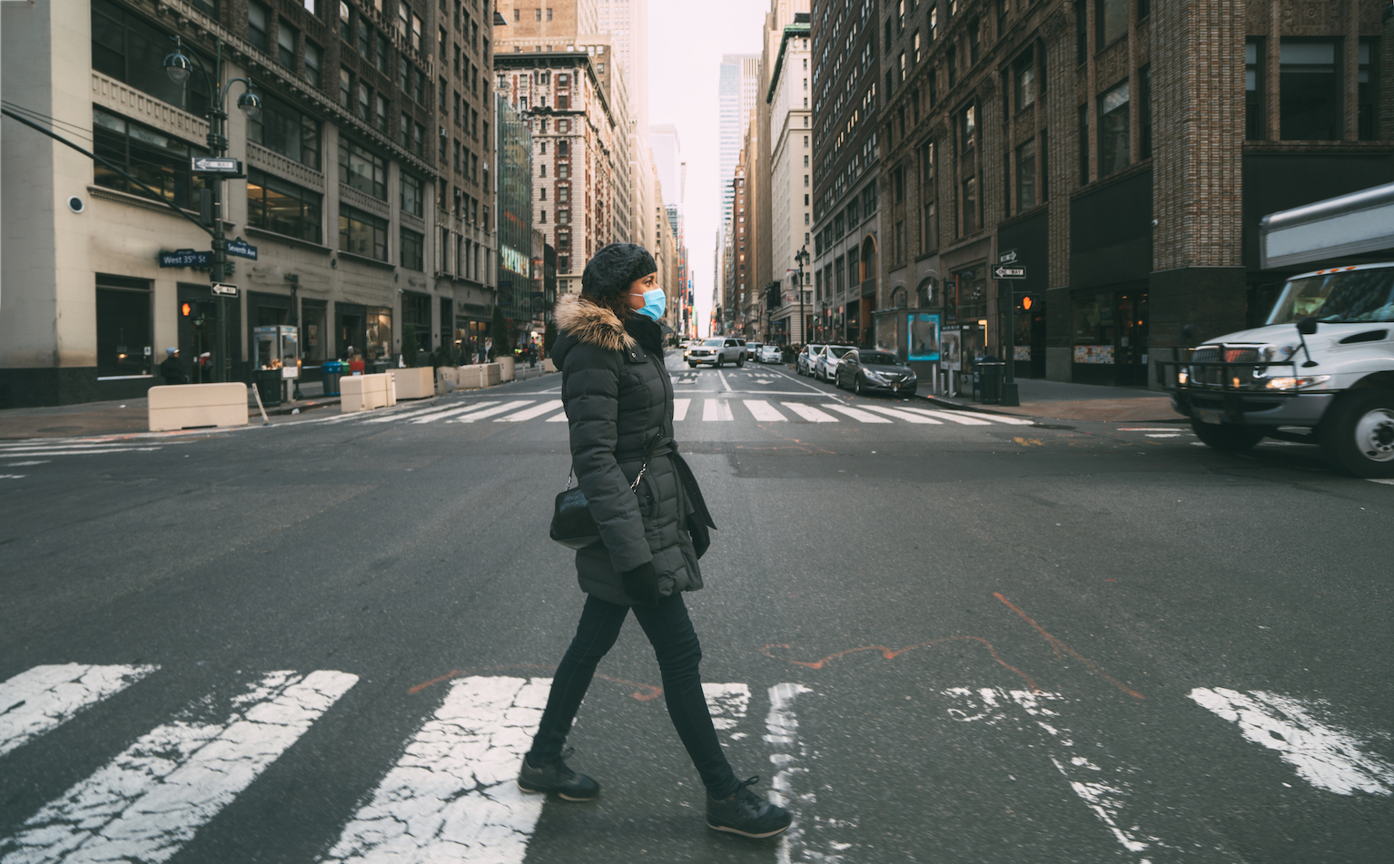 BIG APPLE LIKE NEVER BEFORE: A pedestrian crosses the street in a deserted Manhattan