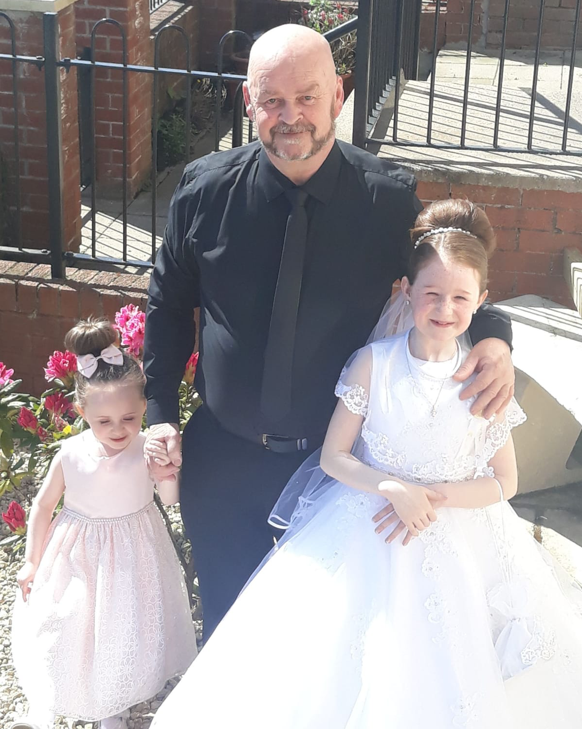 SLAIN: Kieran Wylie with granddaughters Maddison and Mya, who was celebrating her First Holy Communion. (Photo with kind permission of the Wylie family.)