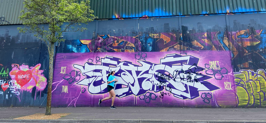 TAKING IT TO THE STREETS: A jogger running in shadow of the peace line during the lockdown. Our photographer Thomas McMullan\'s pictures have captured the pandemic in images. 