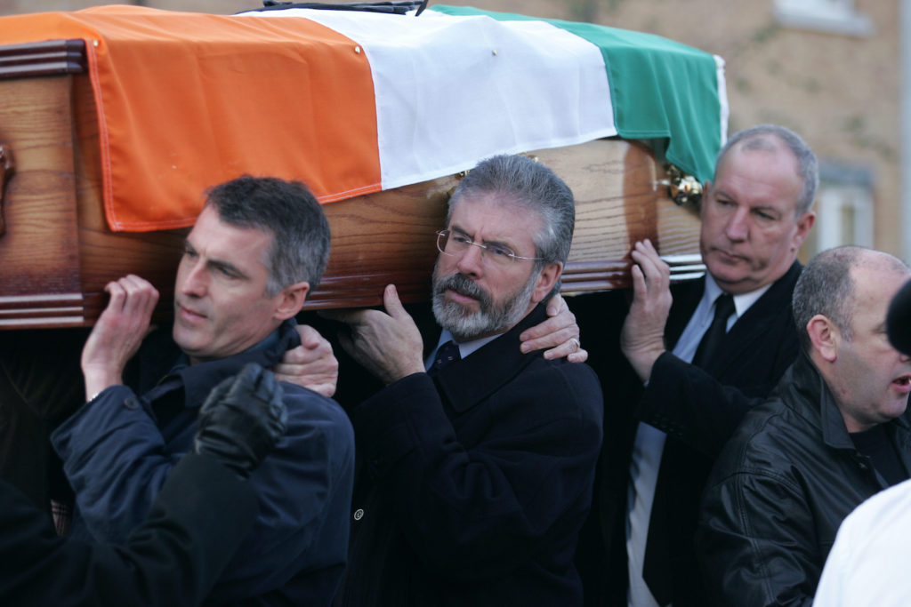 TRIBUTE: Gerry Adams and Bobby Storey (back) help shoulder the coffin of republican activist Martin Meehan in 2007.