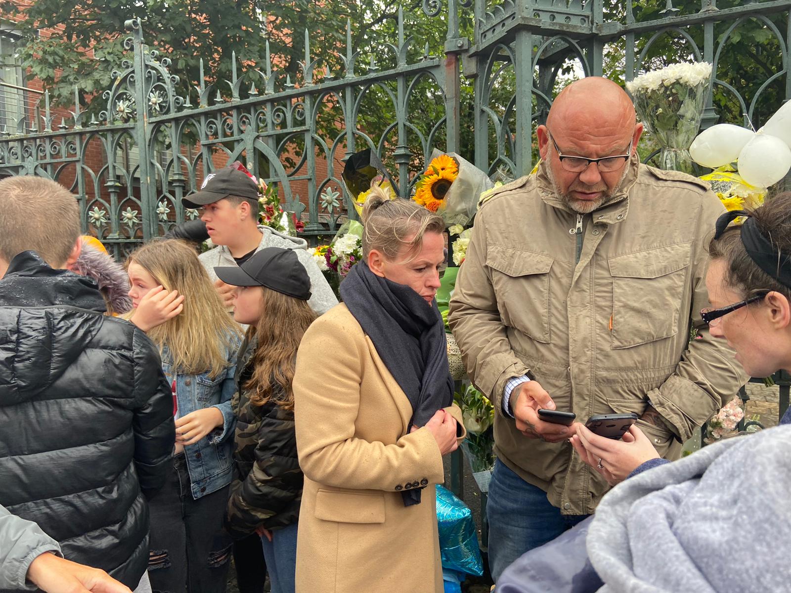 GRIEF: Fiona Donohoe at the gates of St Malachy\'s College where locals had gathered in memory of Noah and in support of his family