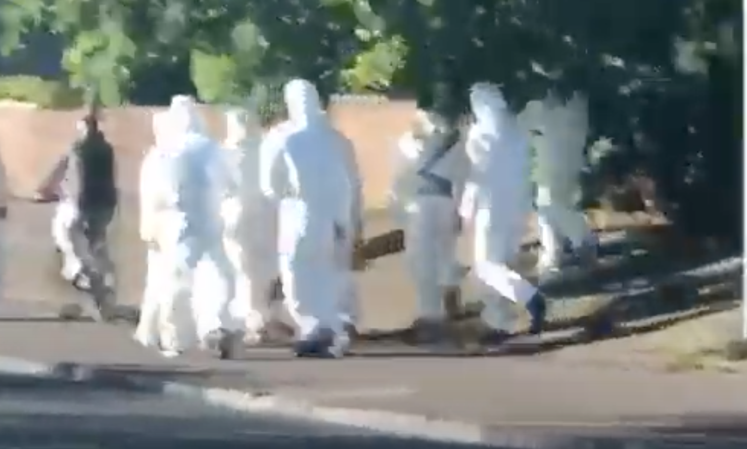 INCIDENT: Police looking for information about this group of men in white boiler suits.